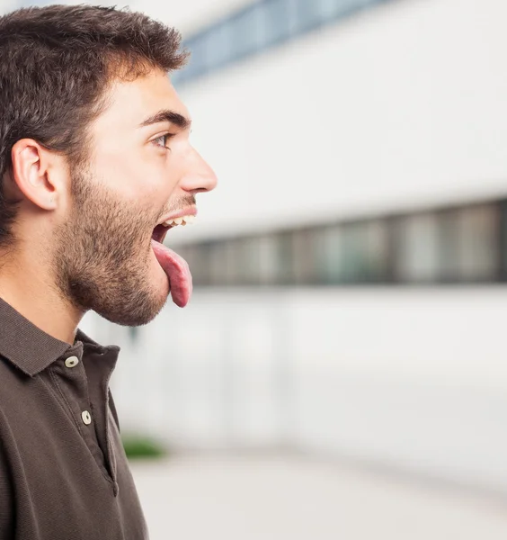 Hombre guapo mostrando su lengua — Foto de Stock