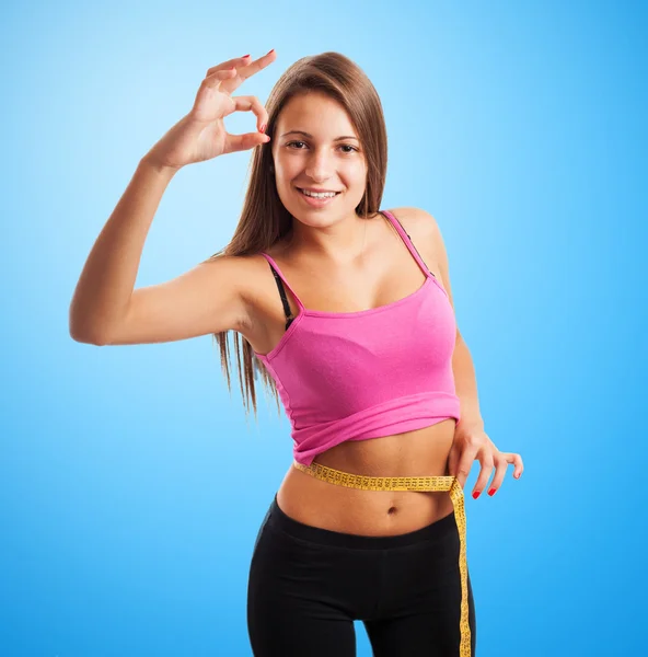 Sporty young girl measuring weight — Stock Photo, Image