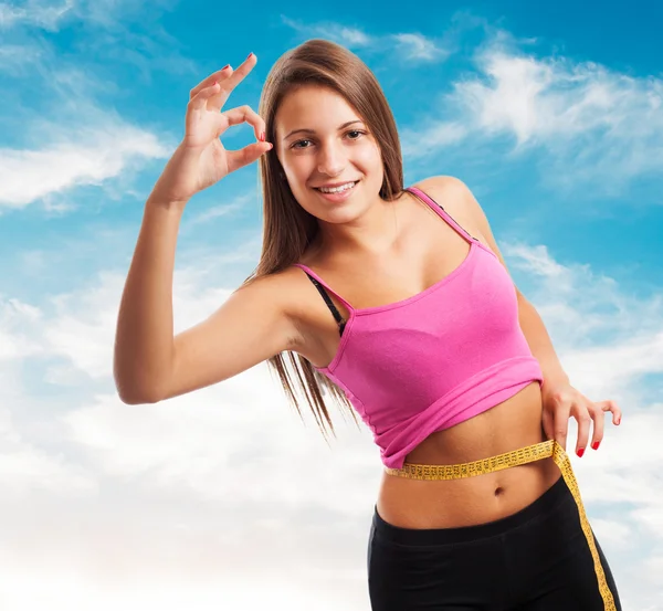 Sporty young girl measuring weight — Stock Photo, Image