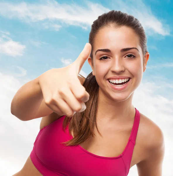 Sporty girl doing positive gesture — Stock Photo, Image