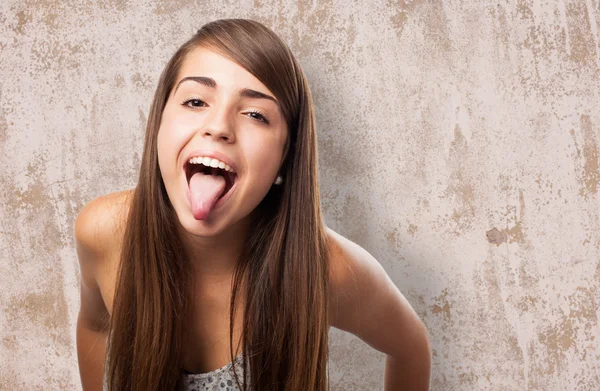Funny young girl showing tongue Royalty Free Stock Images