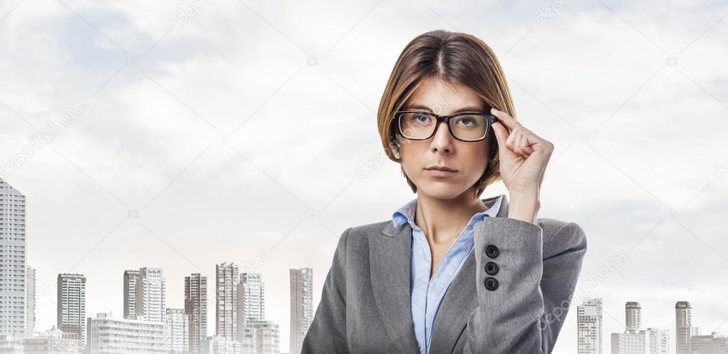 Young woman putting on glasses