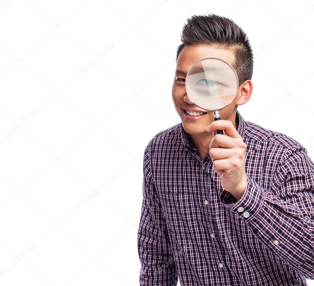 Asian man with magnifying glass