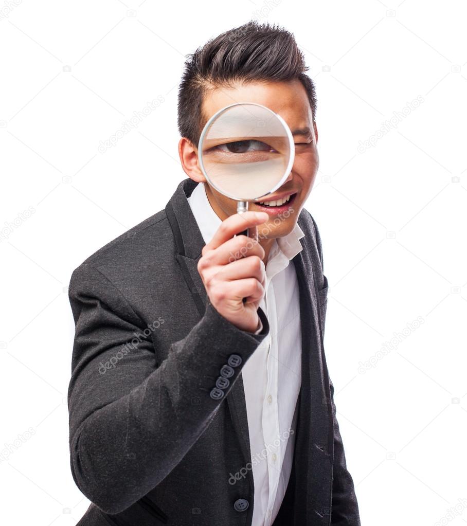 Asian man with magnifying glass