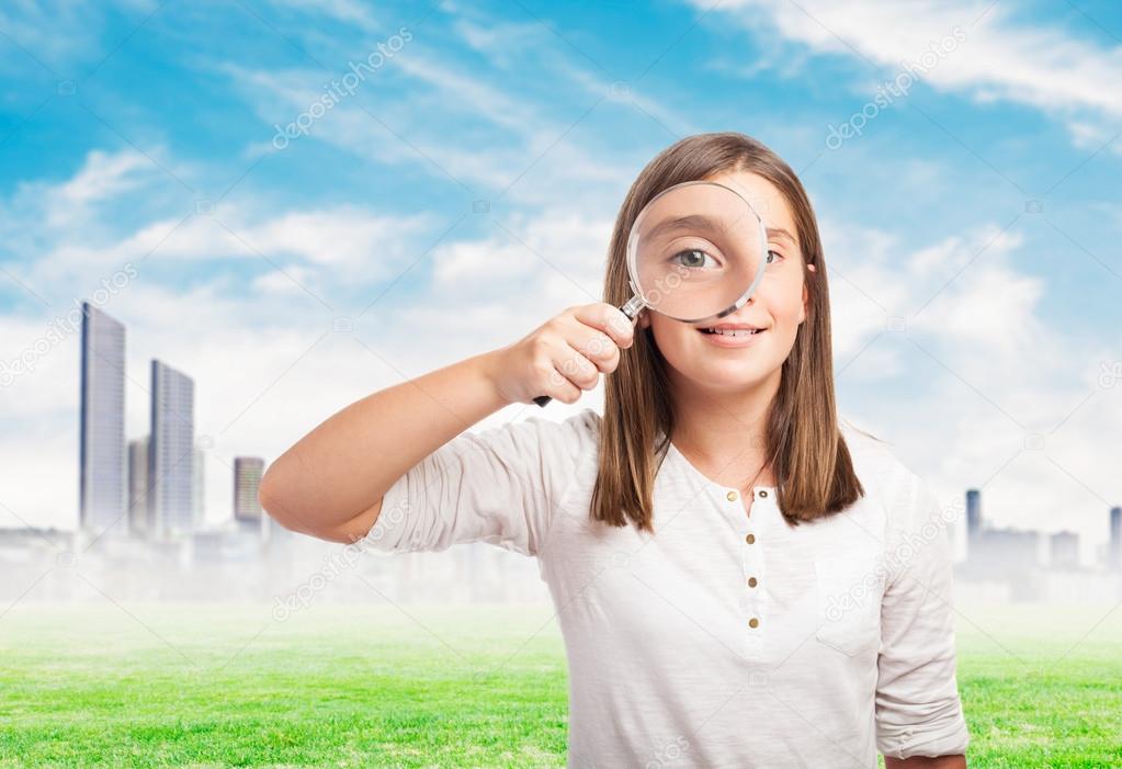 Young girl with magnifying glass