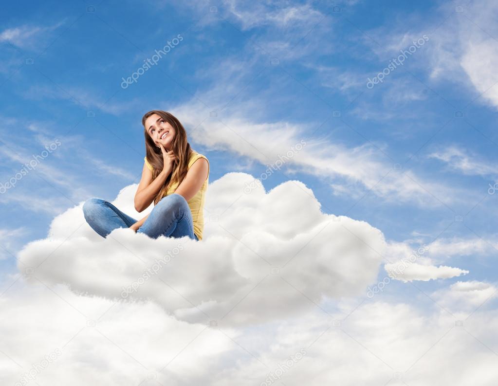 Young pretty woman sitting on cloud