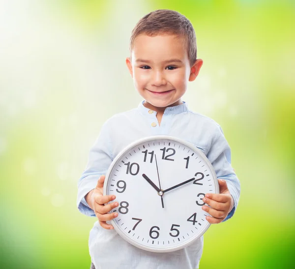 Kleine jongen bedrijf klok — Stockfoto