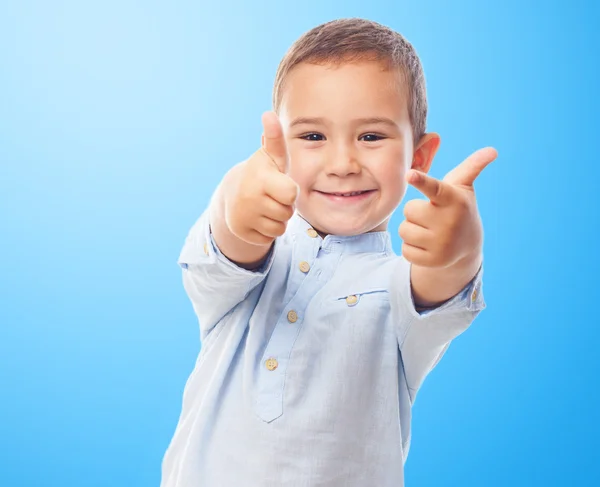 Little boy doing victory gesture — Stock Photo, Image