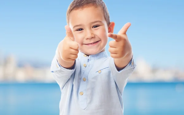Little boy doing victory gesture — Stock Photo, Image