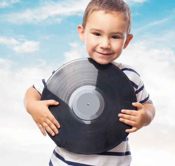 Little boy holding vinyl record — Stock Photo, Image