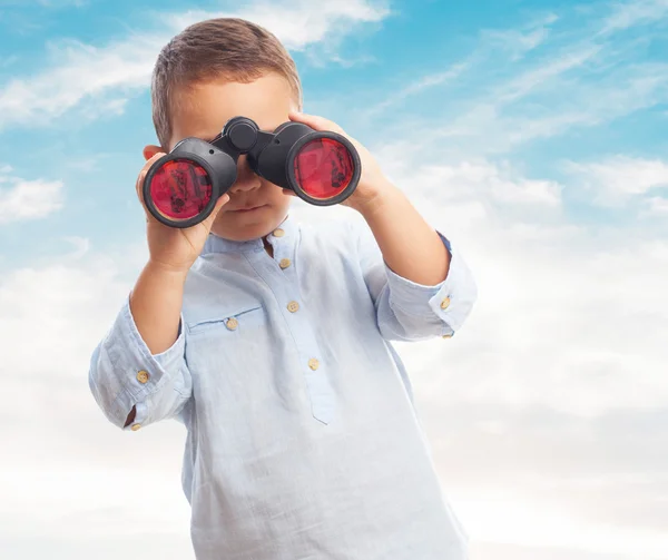 Little boy looking through binoculars — Stock Photo, Image