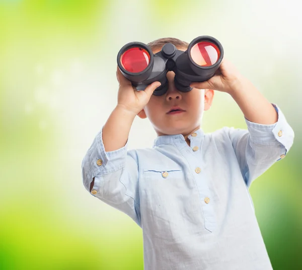 Little boy looking through binoculars — Stock Photo, Image