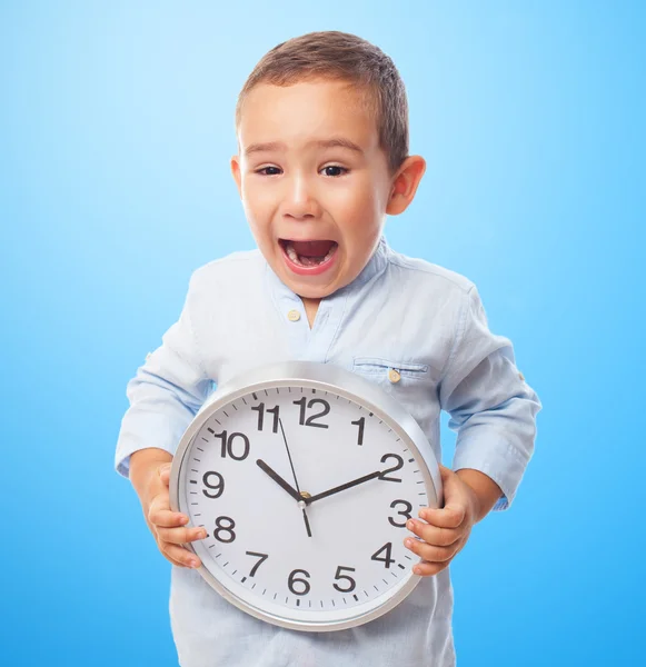Liten pojke anläggning klocka — Stockfoto