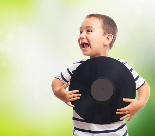 Little boy holding vinyl record — Stock Photo, Image