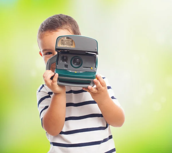 Little boy taking photos with polaroid — Stock Photo, Image