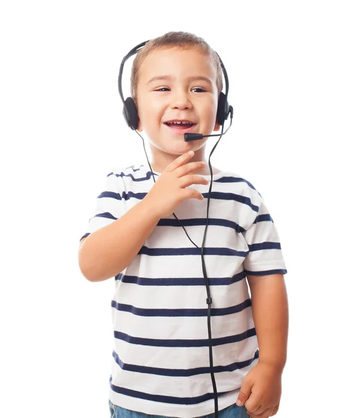 Menino falando por fone de ouvido — Fotografia de Stock