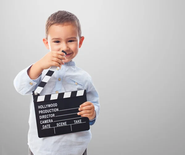 Little boy holding clapper board — Stock Photo, Image