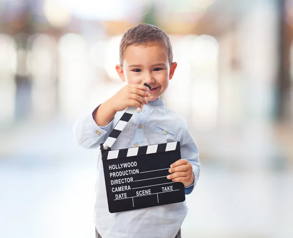 Little boy holding clapper board — Stock Photo, Image