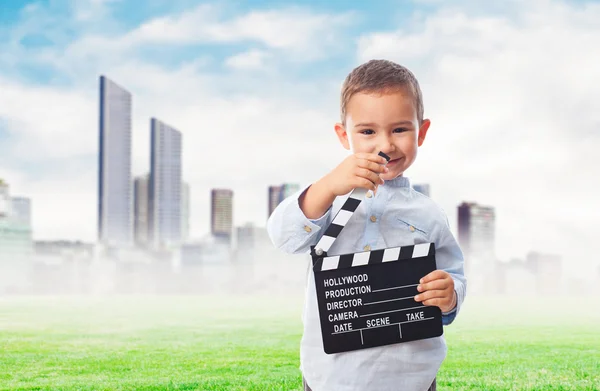 Little boy holding clapper board — Stock Photo, Image