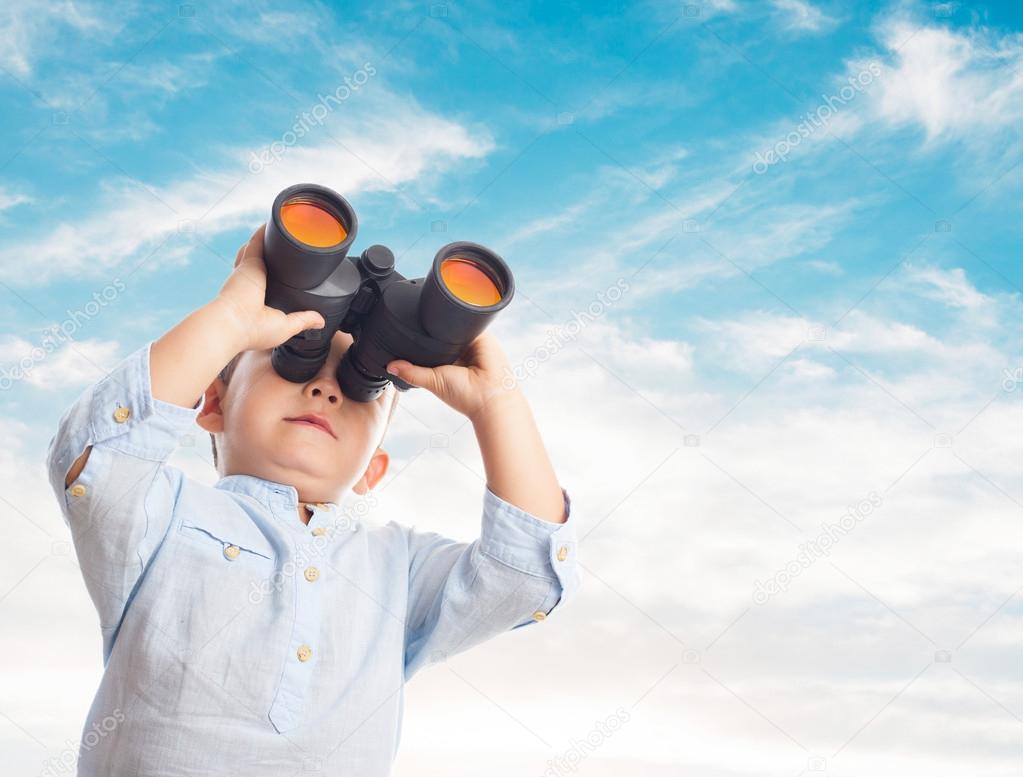 Little boy looking through binoculars