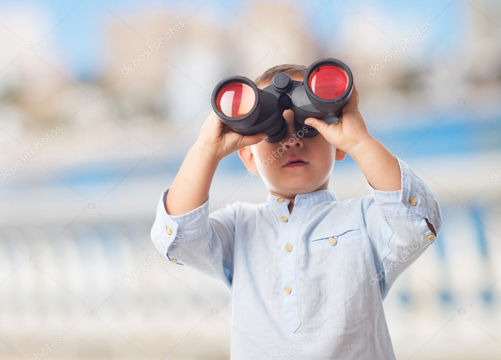 Little boy looking through binoculars