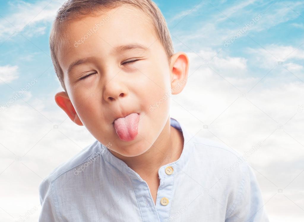 Little boy sticking out tongue