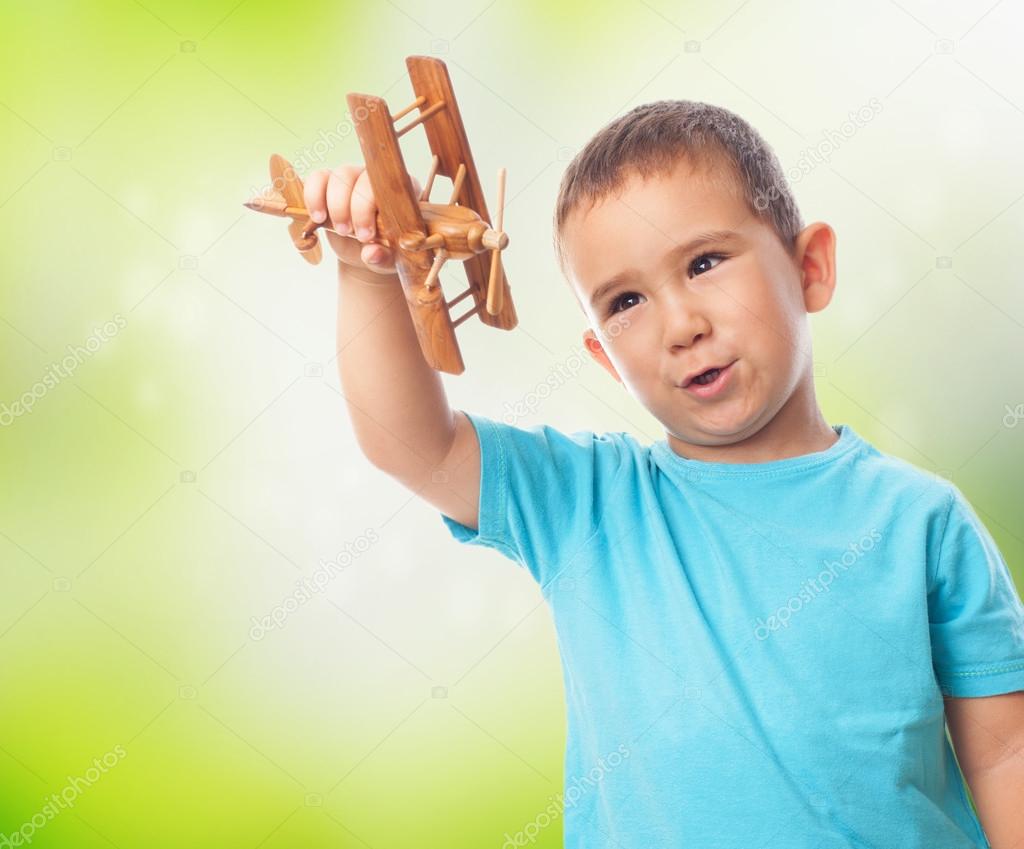 Little boy playing with plane