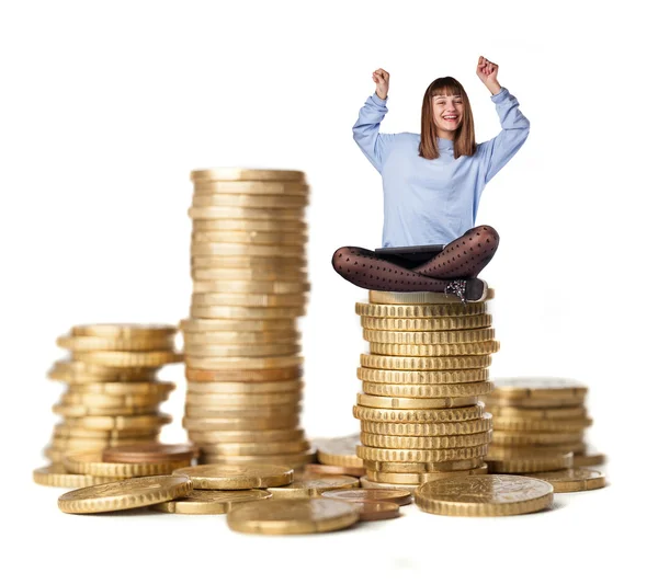 Young woman winner on coins tower — Stock Photo, Image