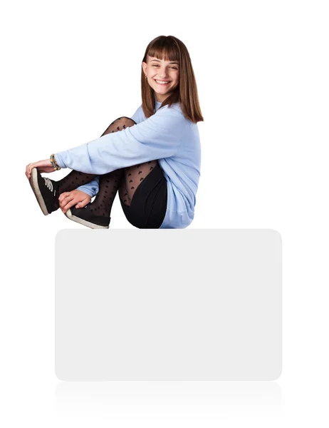 Young woman sitting on white box — Stock Photo, Image