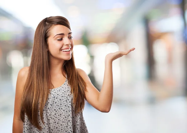 Pretty young woman holding something — Stock Photo, Image