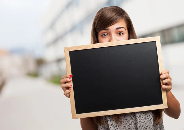 Student hidden behind chalkboard — Stock Photo, Image