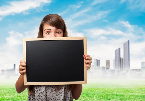 Student hidden behind chalkboard — Stock Photo, Image