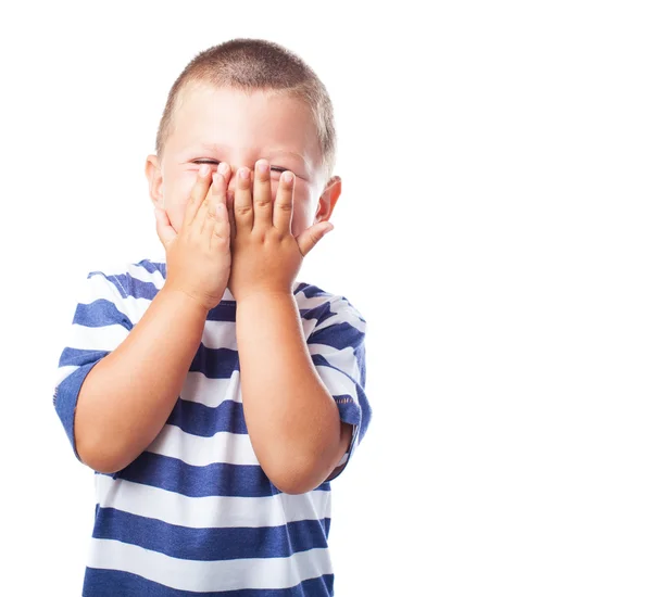 Leuke jongen verbergen van zijn gezicht — Stockfoto