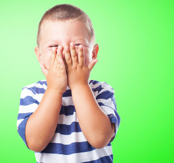 Fun kid hiding his face