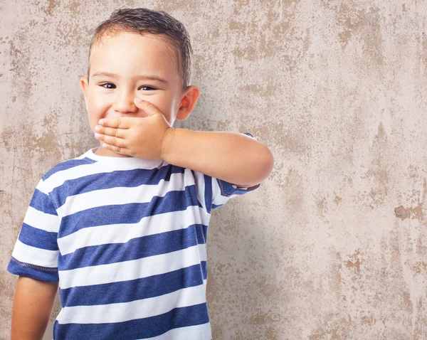 Cute kid covering his mouth — Stock Photo, Image