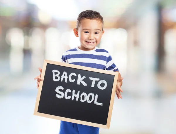 Cute kid holding chalkboard — Stock Photo, Image
