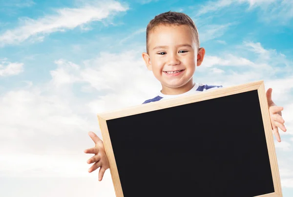 Cute kid holding chalkboard — Stock Photo, Image