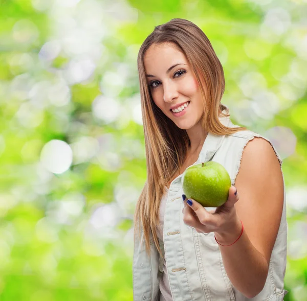 Pretty young woman offering apple — Stock Photo, Image