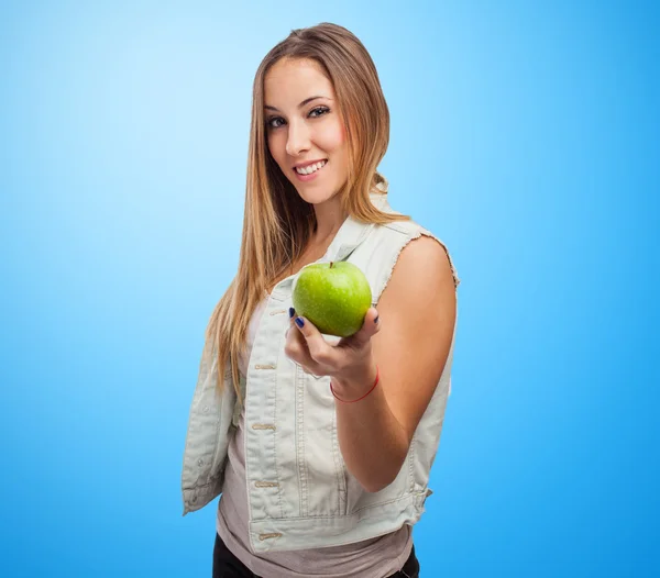 Pretty young woman offering apple — Stock Photo, Image