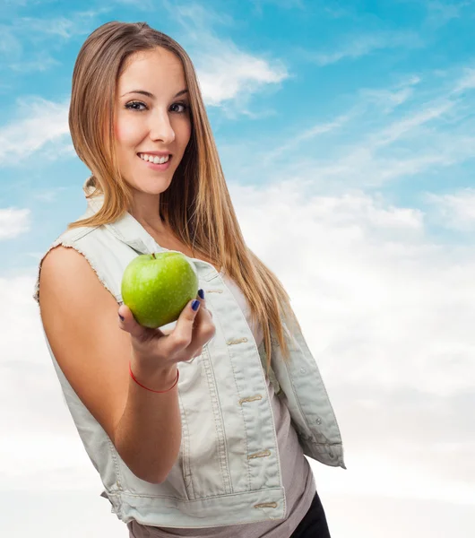 Pretty young woman offering apple — Stock Photo, Image