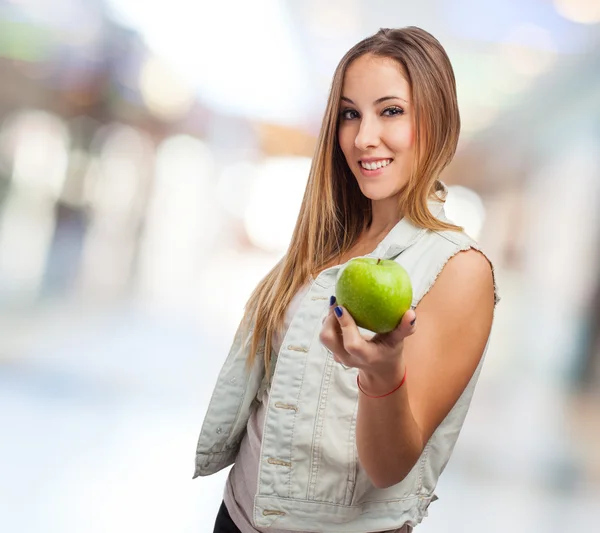 Pretty young woman offering apple — Stock Photo, Image