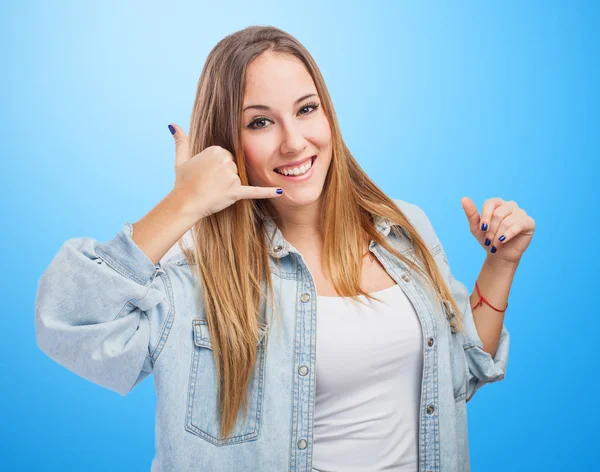 Young woman making gesture to call — Stock Photo, Image