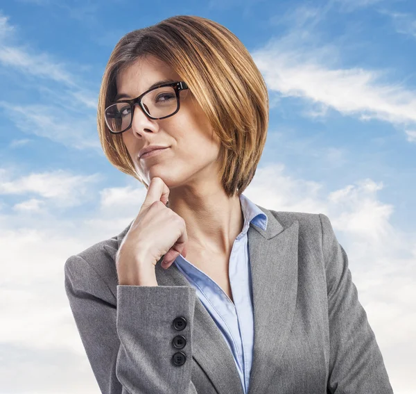 Executive young woman in pensive gesture — Stock Photo, Image
