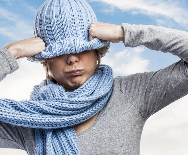 Woman covering head with wool cap — Stock Photo, Image