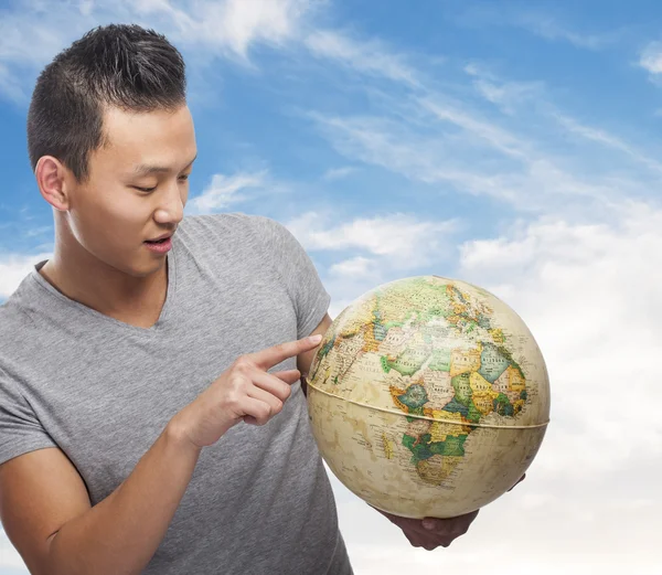 Asian man with globe — Stock Photo, Image