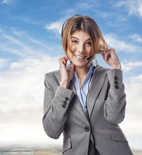 Businesswoman talking on headphones — Stock Photo, Image