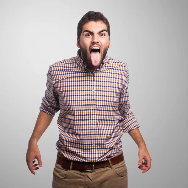 Young man showing his tongue — Stock Photo, Image