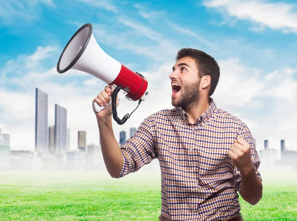 Handsome man shouting with megaphone — Stock Photo, Image