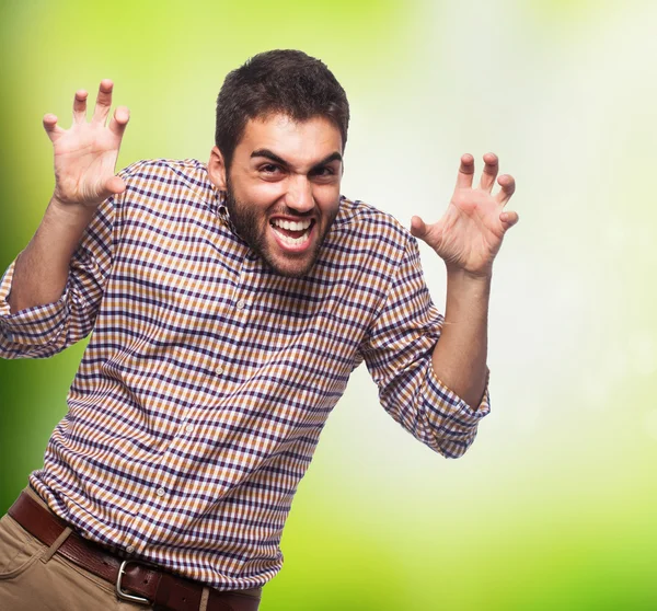 Young man doing aggressive gesture — Stock Photo, Image