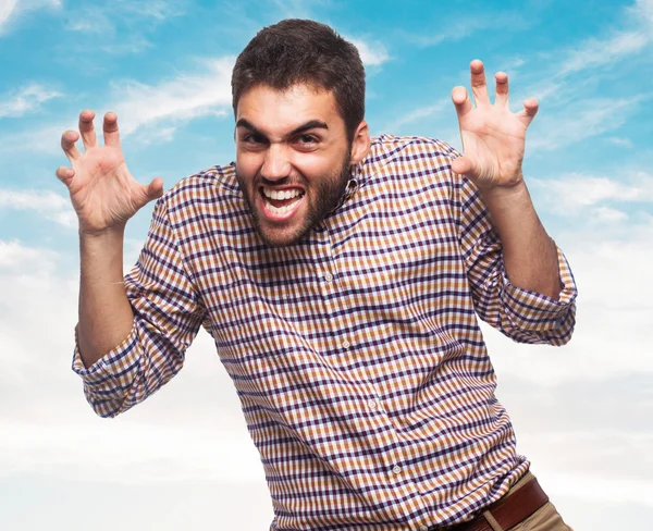 Young man doing aggressive gesture — Stock Photo, Image